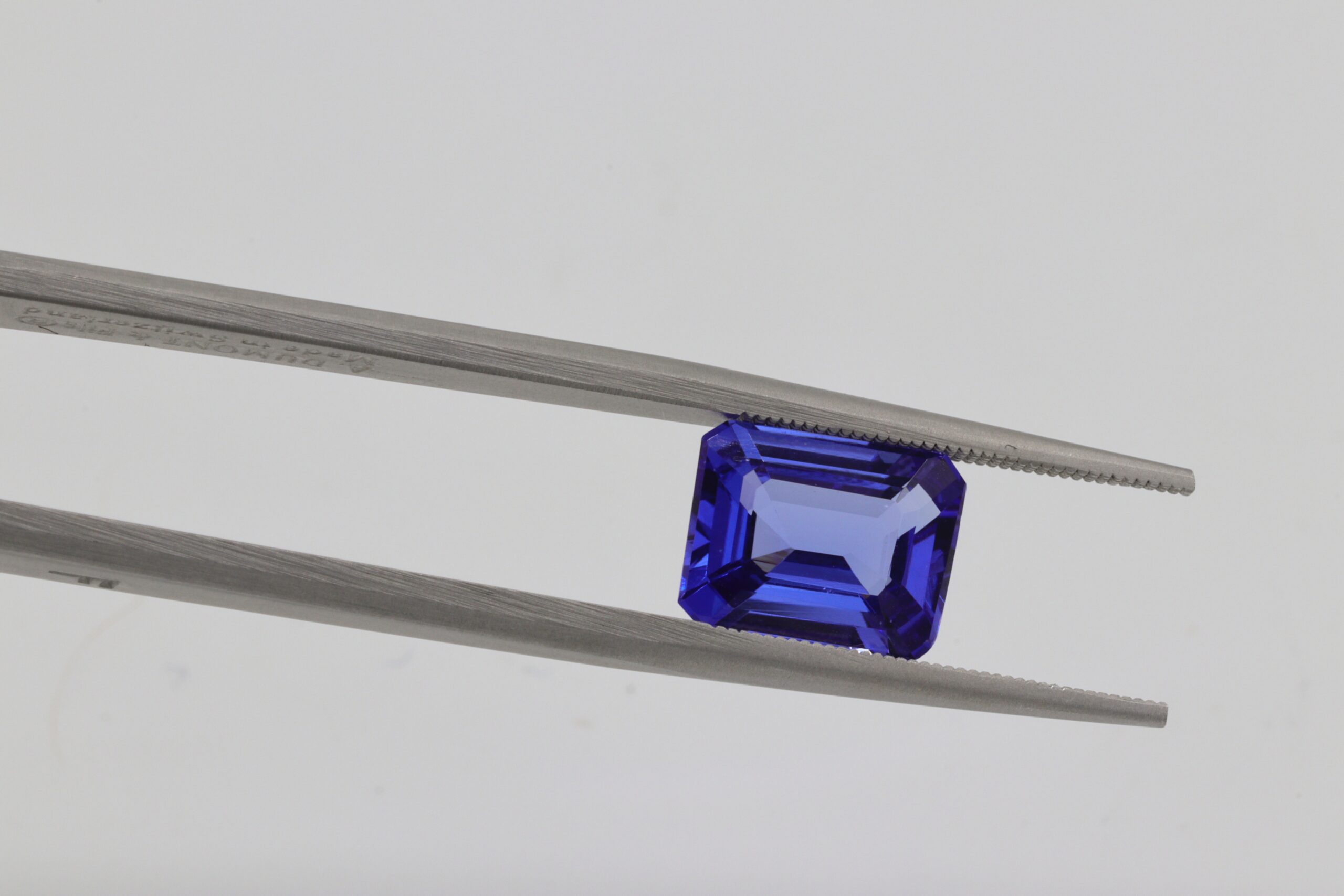 A sapphire held by a tool