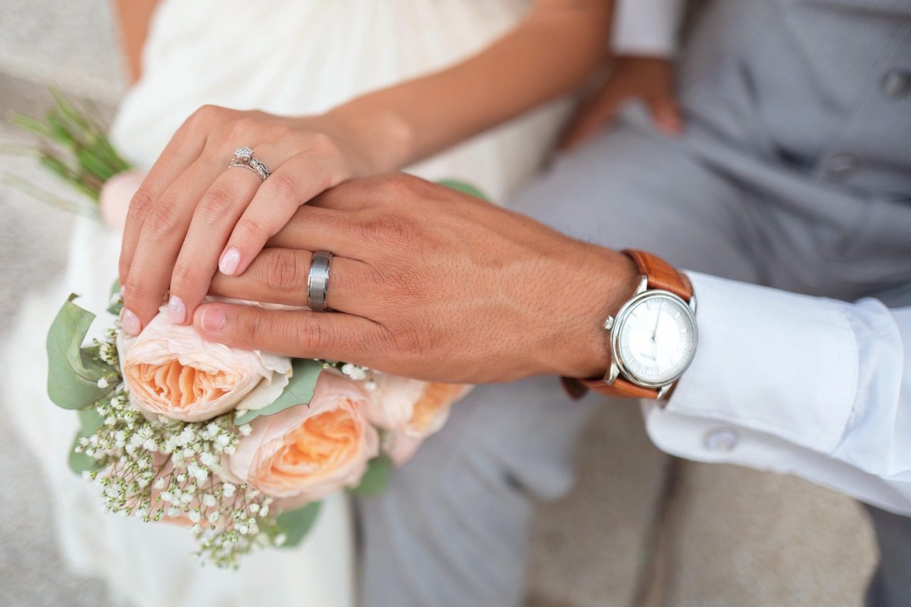 newly married couple hands touching