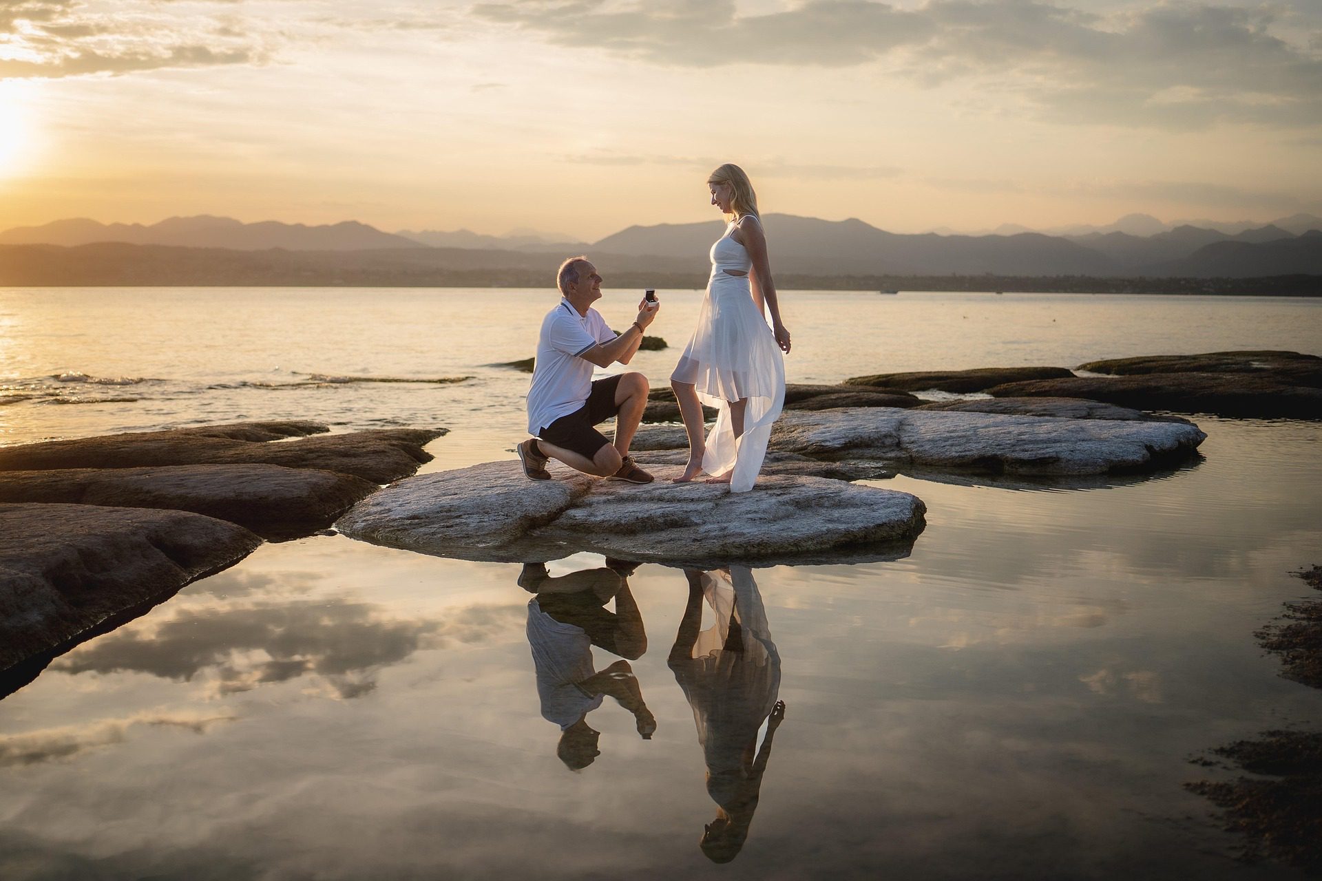 Man proposing to a woman over water