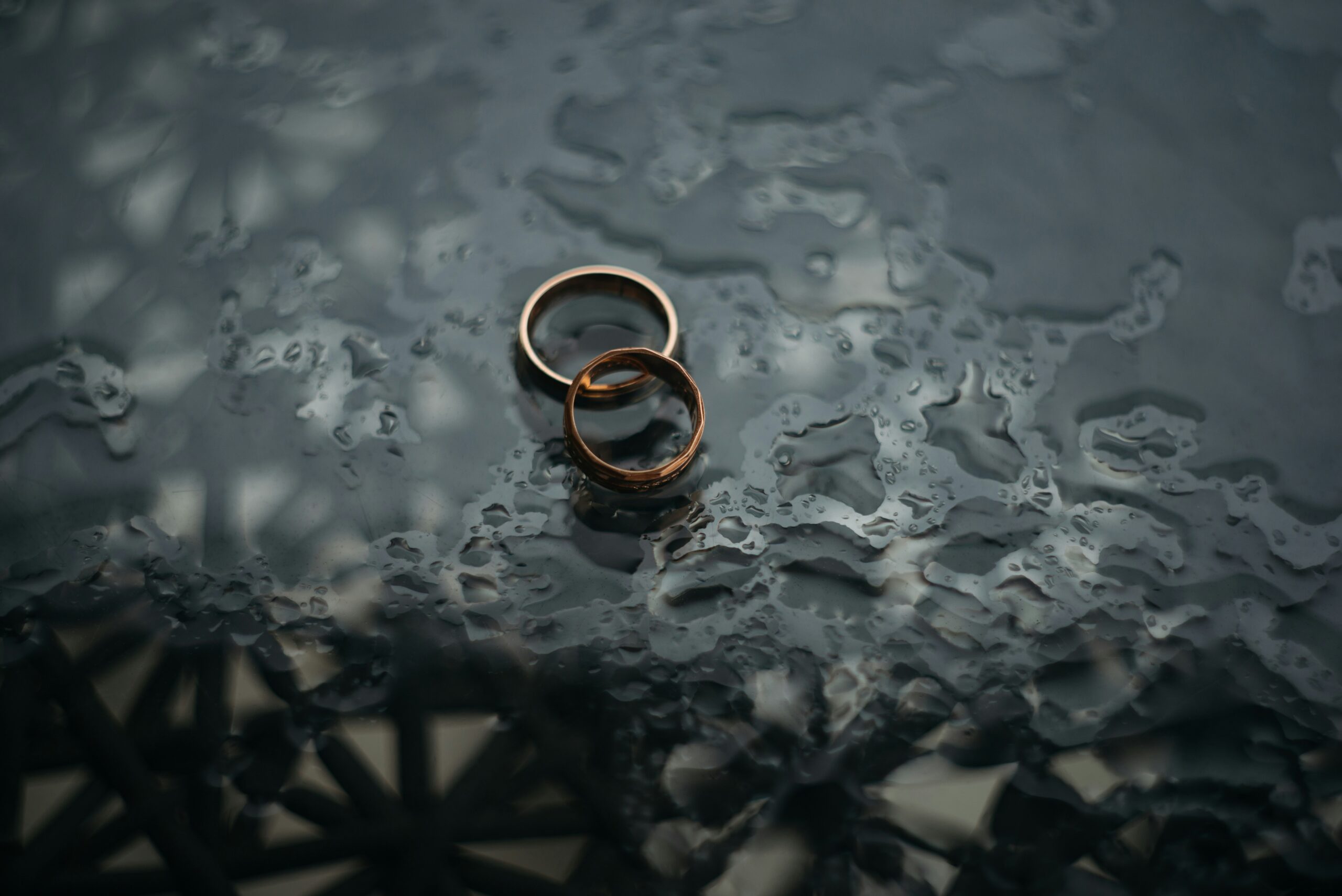 Two rings laying on a surface in the rain