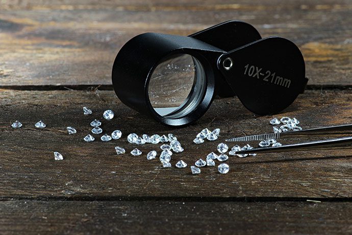 diamonds with a measuring scope and tweezers